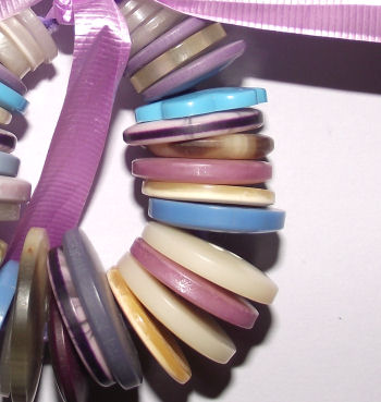 Button wreath Christmas tree decoration - detail of stacked buttons