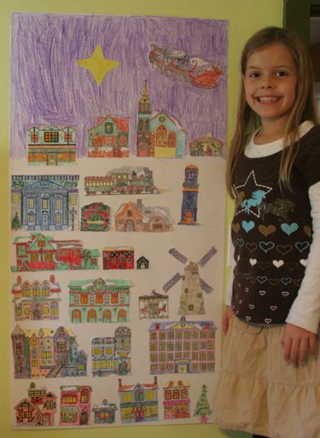 The completed Christmas Village colouring advent calendar proudly displayed on a wall