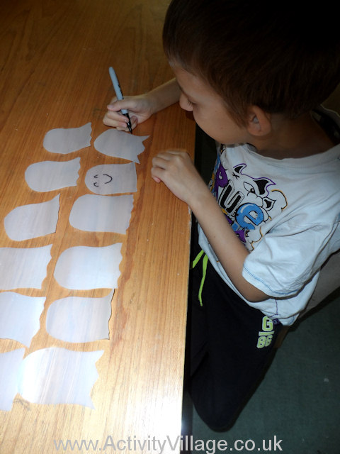 Plastic Milk Bottle Ghosts - Sam drawing on faces