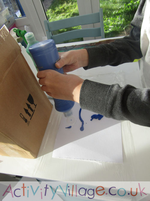 Sam squidging paint onto watercolour paper